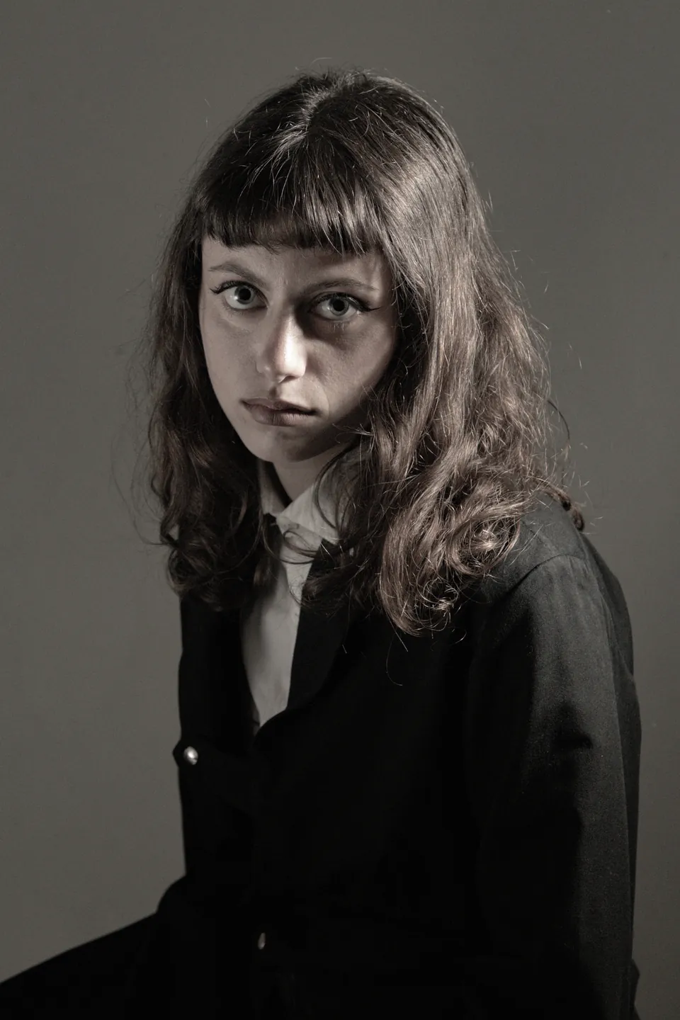 Office Monotony campaign image: reinterpreted tailored officewear silhouette